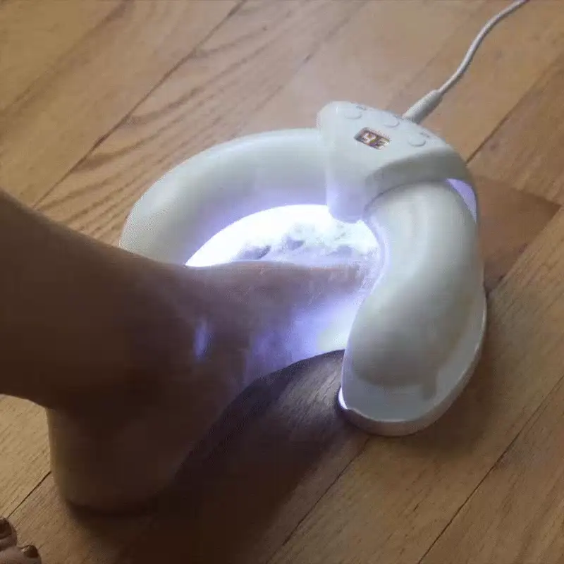 Person gently brushing the treatment onto their toes after showering